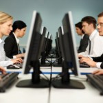 Image of smart people sitting at the tables at computer class