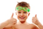 child with goggles and thumbs up