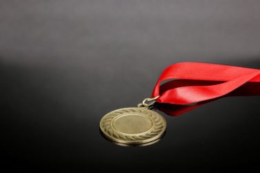 Gold medal on grey background