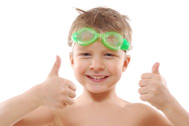 child with goggles and thumbs up