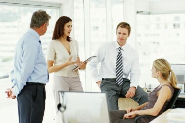 Two businessmen and two businesswomen having discussion in office