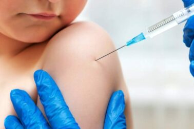 Boy and vaccine syringe