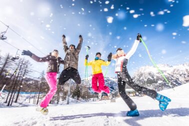 Group of friends with ski on winter holidays - Skiers having fun on the snow