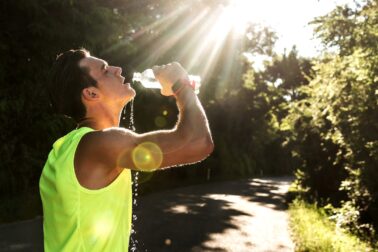 Jogger in the park drinking water
